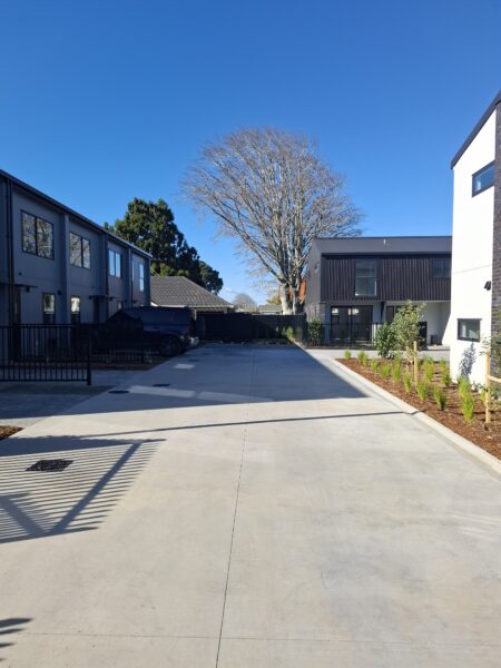 Shared driveway between completed townhouses, rated for 10-tonne loading with StormSlab tanks below