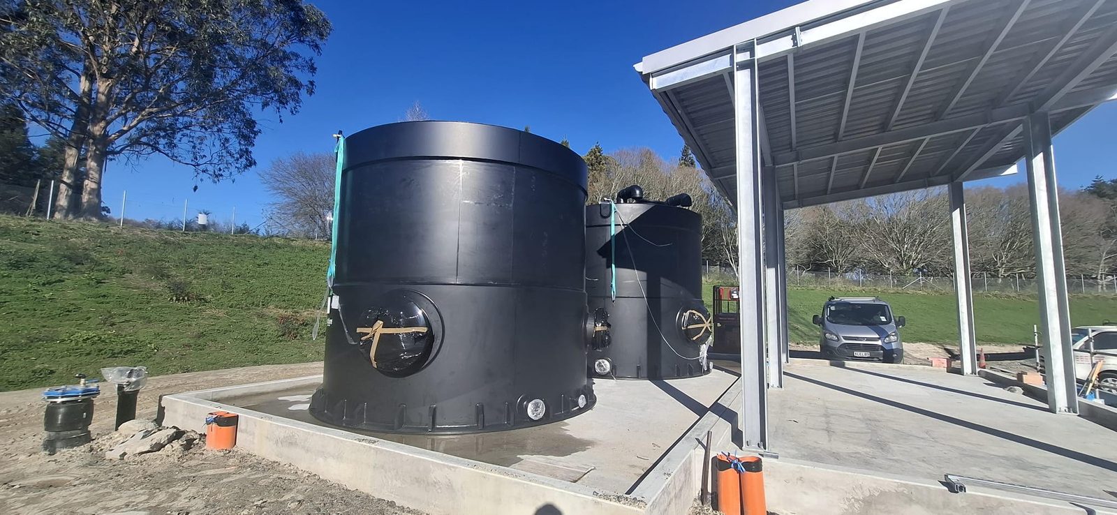 Two HazSure HDPE service water tanks installed on the concrete pad under the canopy at the Pukete inlet works